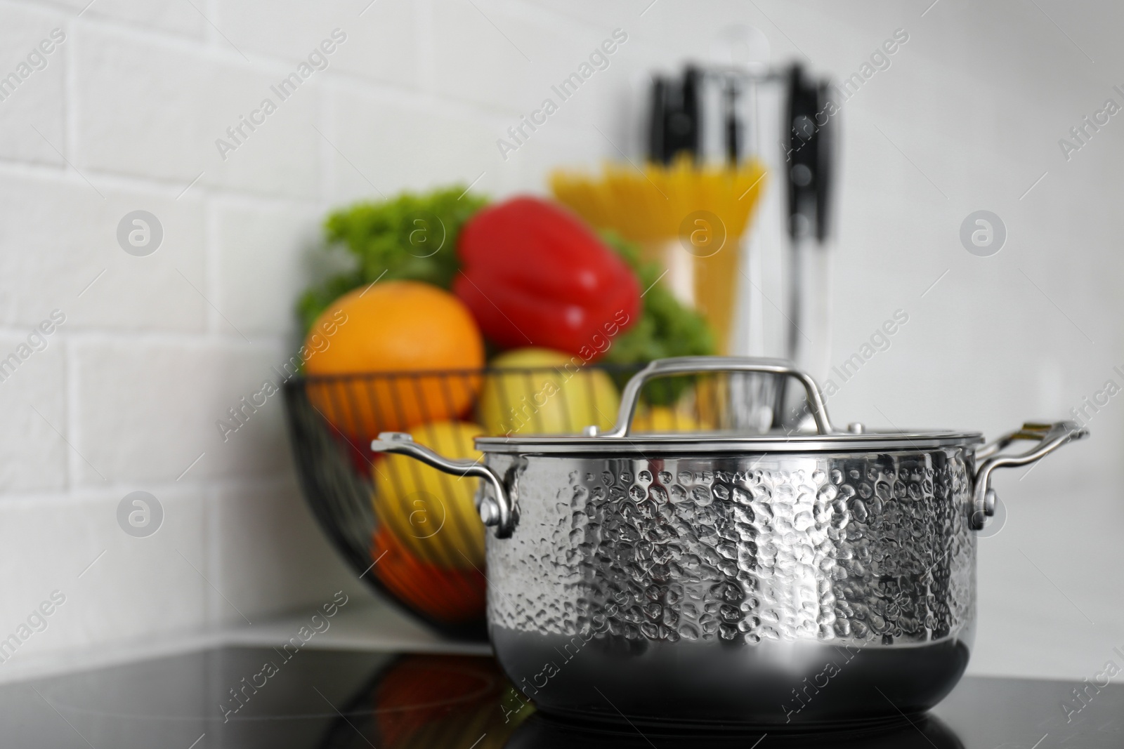 Photo of New saucepot on induction stove in kitchen