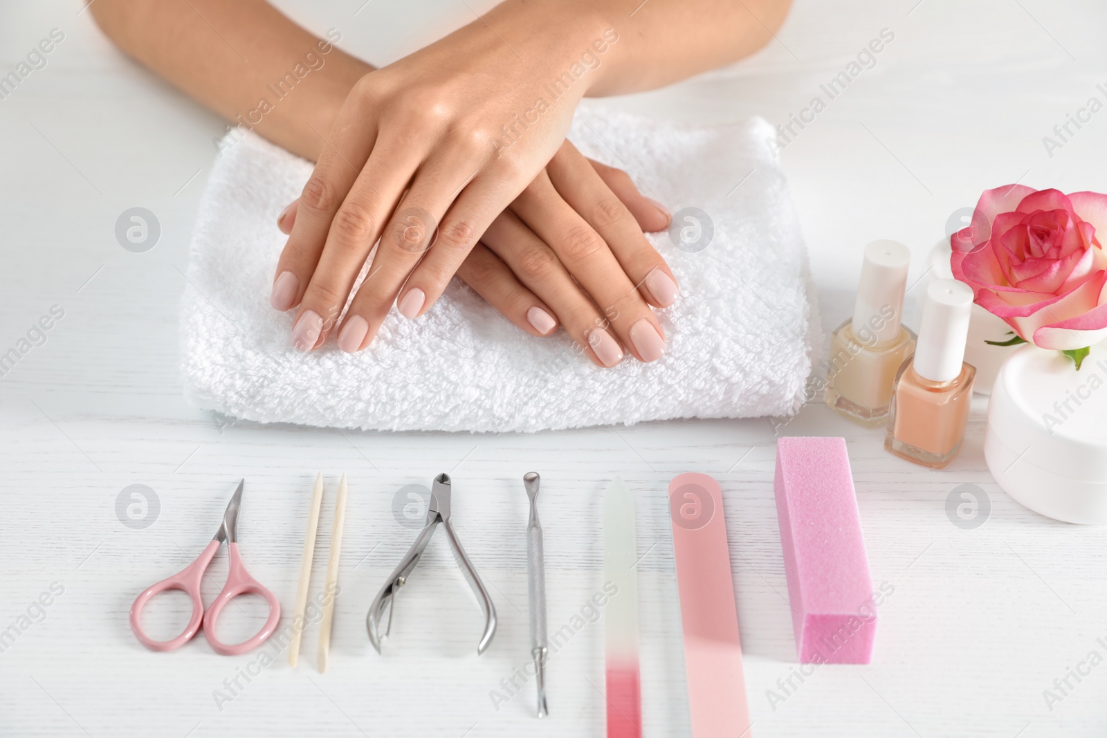 Photo of Woman waiting for manicure and tools on table, closeup. Spa treatment