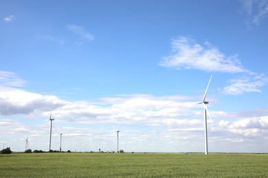 Photo of Beautiful view of field with wind turbines. Alternative energy source