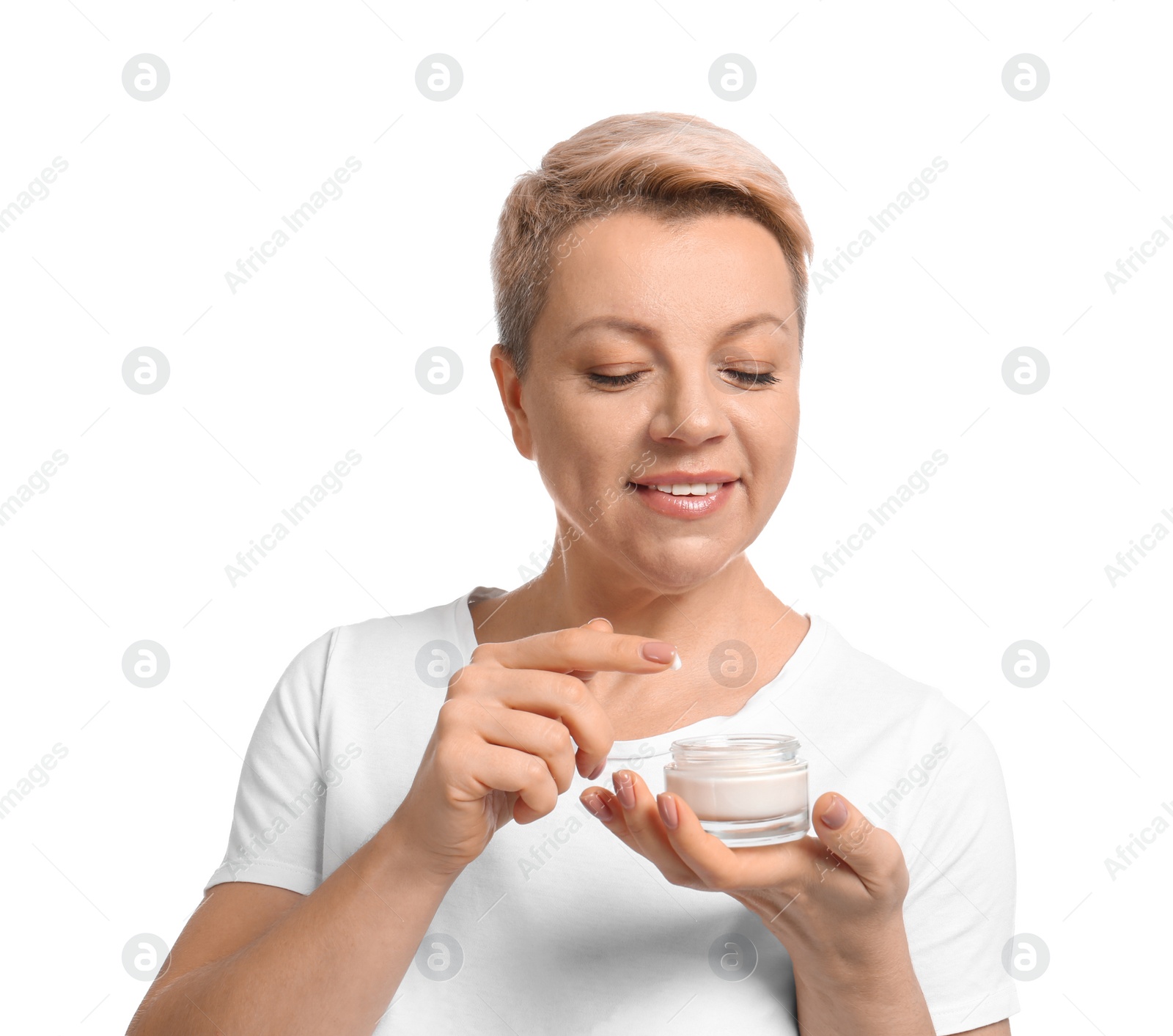 Photo of Mature woman with jar of face cream on white background