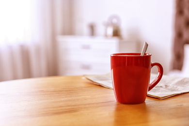 Photo of Morning coffee on wooden table indoors. Space for text