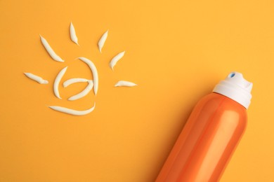 Drawing of sun and bottle with sunscreen on orange background, top view. Skin protection