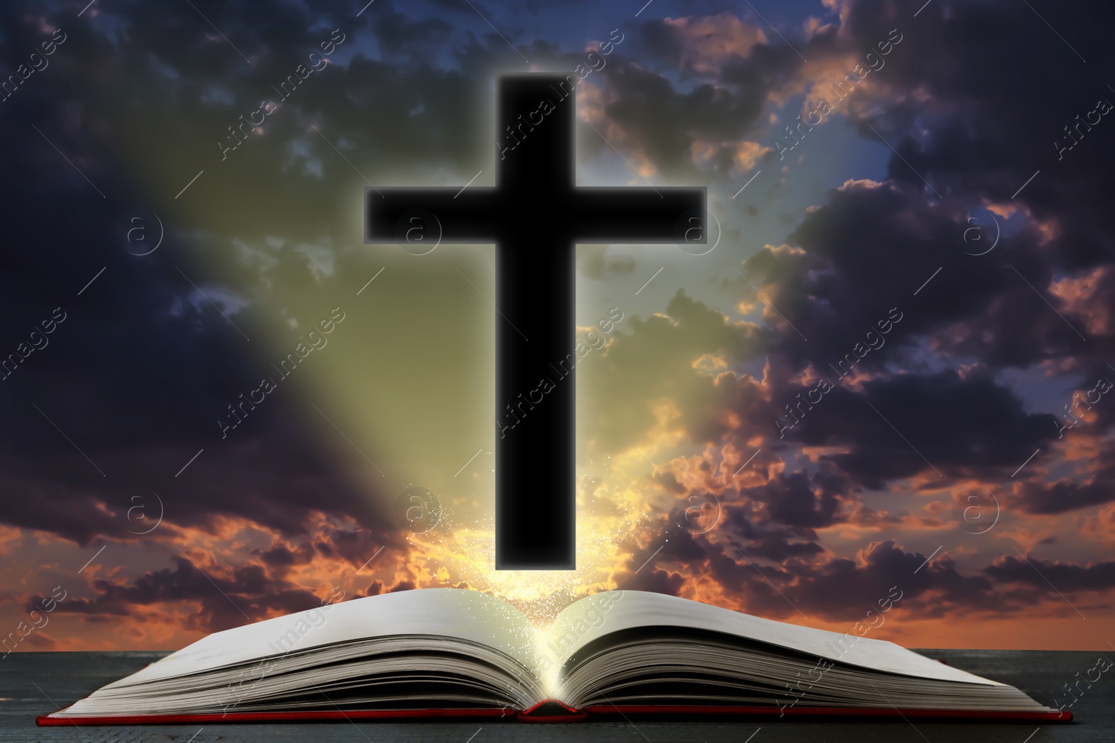 Image of Silhouette of cross and open Bible on table against cloudy sky