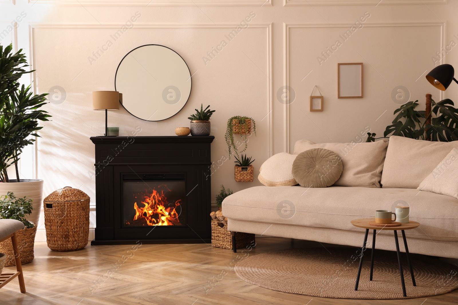 Photo of Stylish living room interior with electric fireplace, comfortable sofa and beautiful decor elements