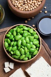 Different organic soy products on grey wooden table, flat lay