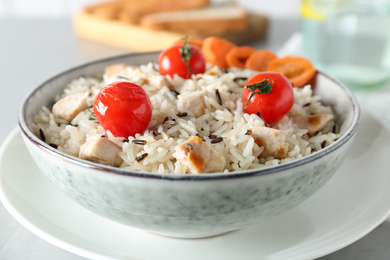 Delicious rice in bowl served on table, closeup