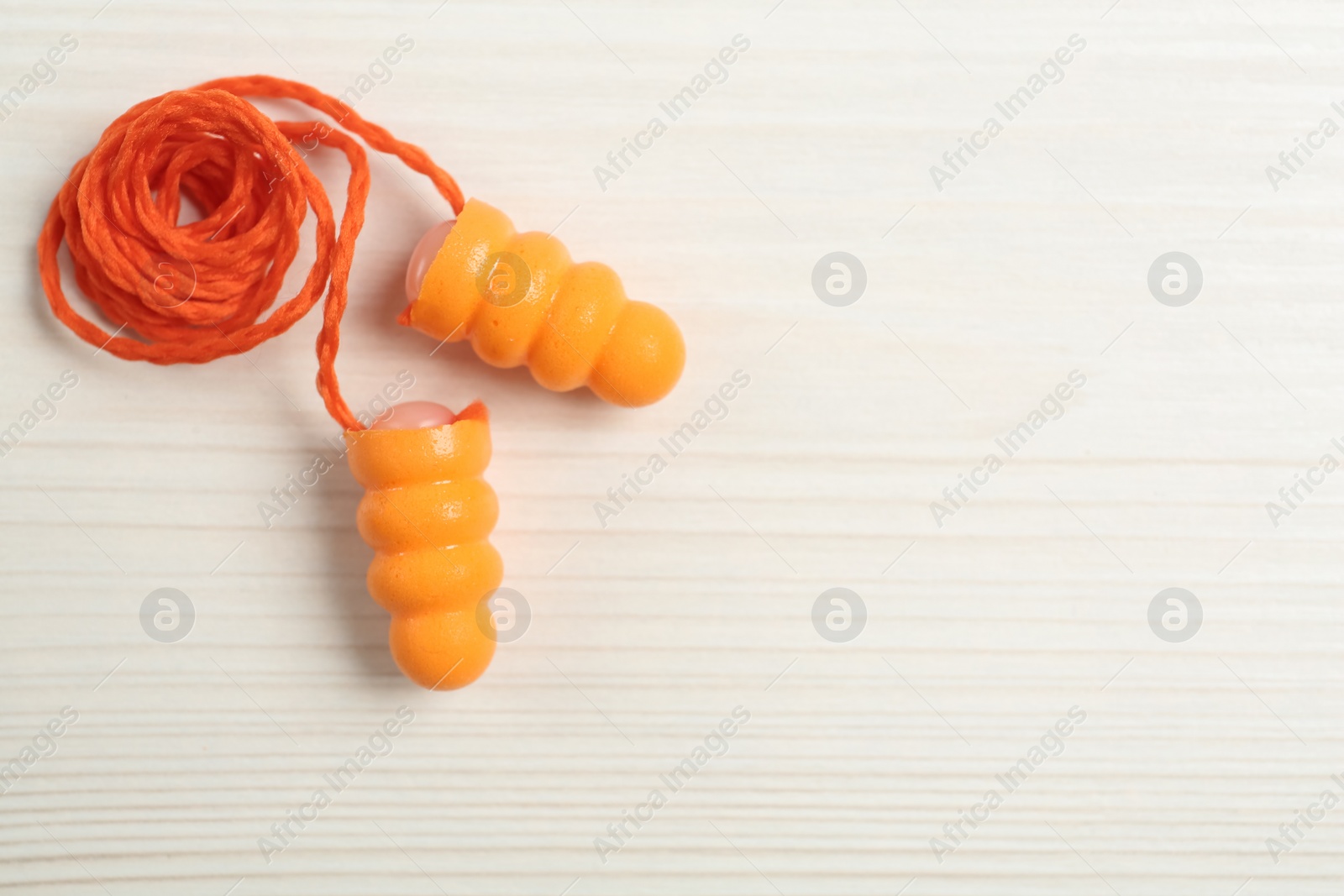 Photo of Pair of ear plugs on white wooden background, flat lay. Space for text