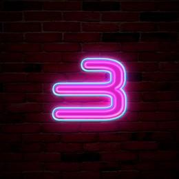 Image of Glowing neon number 3 sign on brick wall