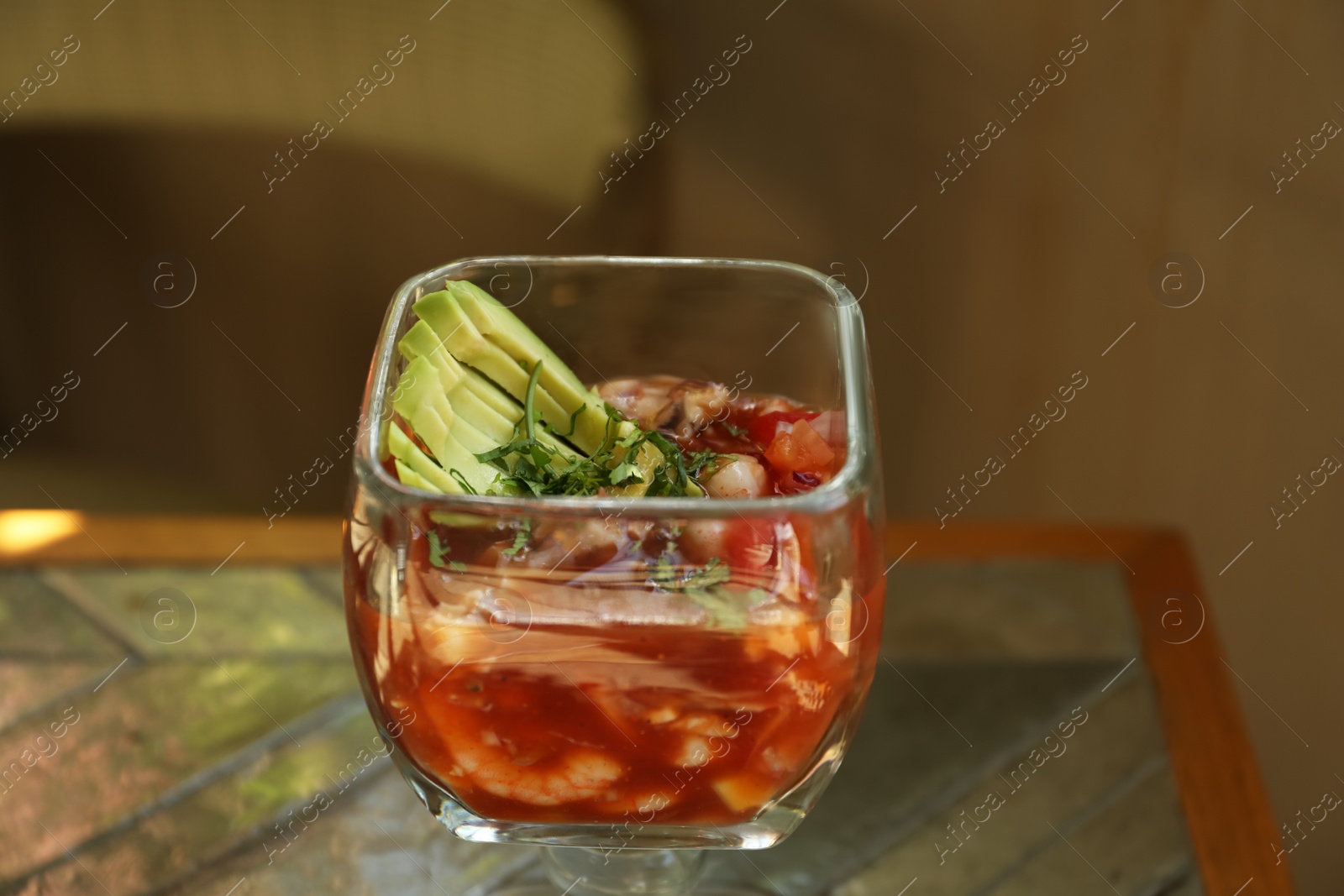 Photo of Delicious campechana cocktail with shrimps on table, closeup