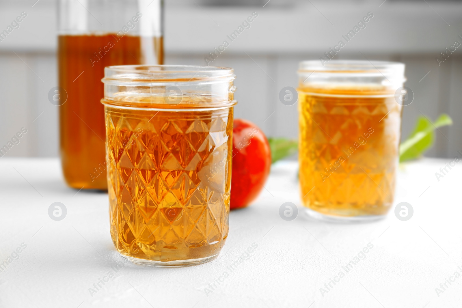 Photo of Jar with fresh apple juice on table