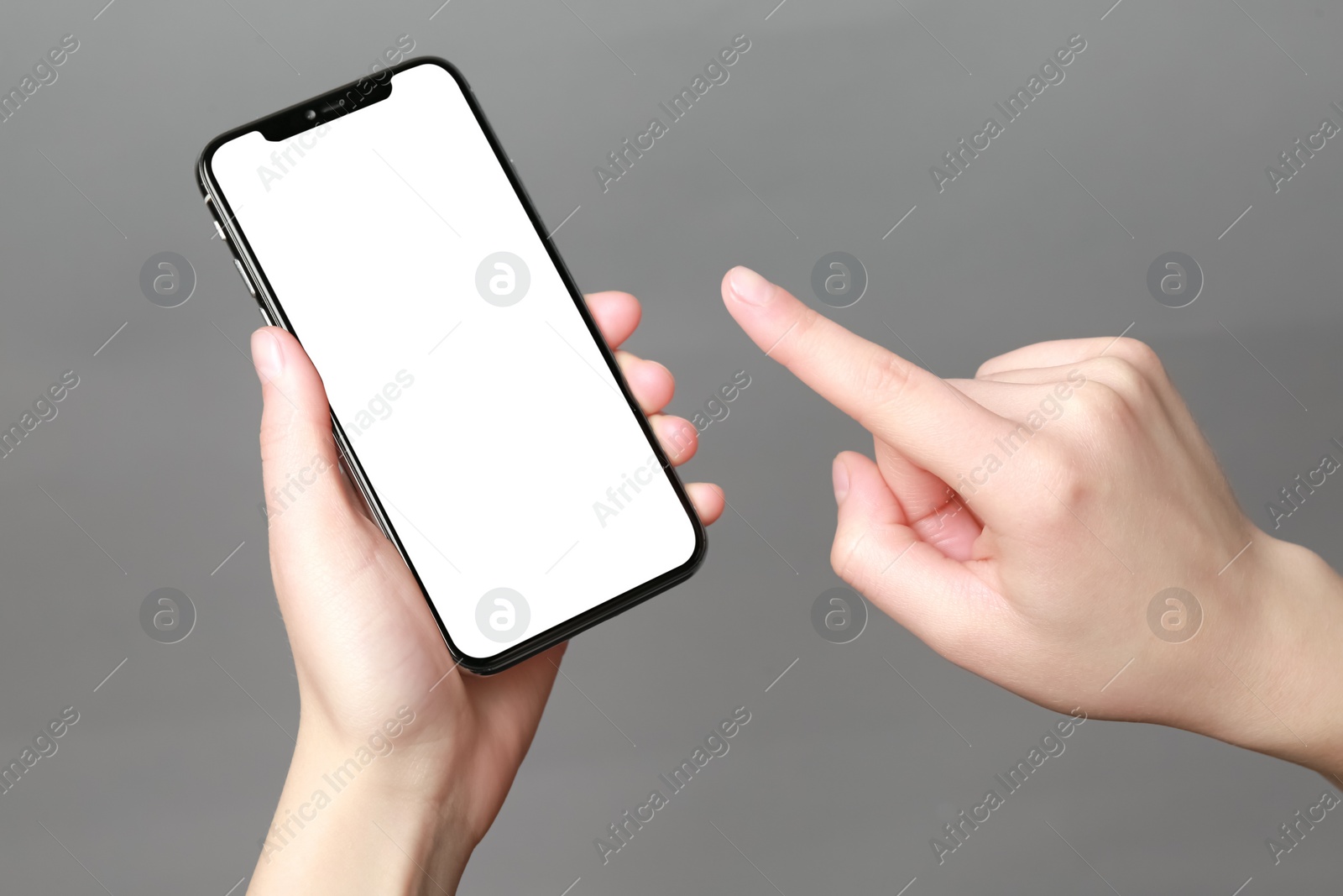 Photo of Woman using smartphone on grey background, closeup. Mockup for design