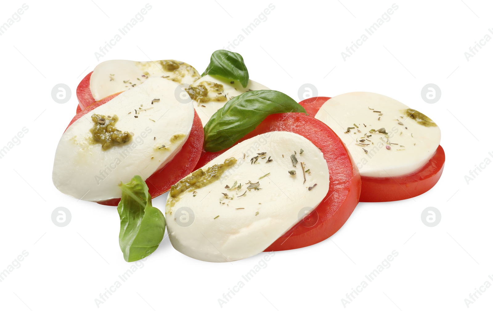 Photo of Tasty salad Caprese with mozzarella, tomatoes, basil and pesto sauce isolated on white