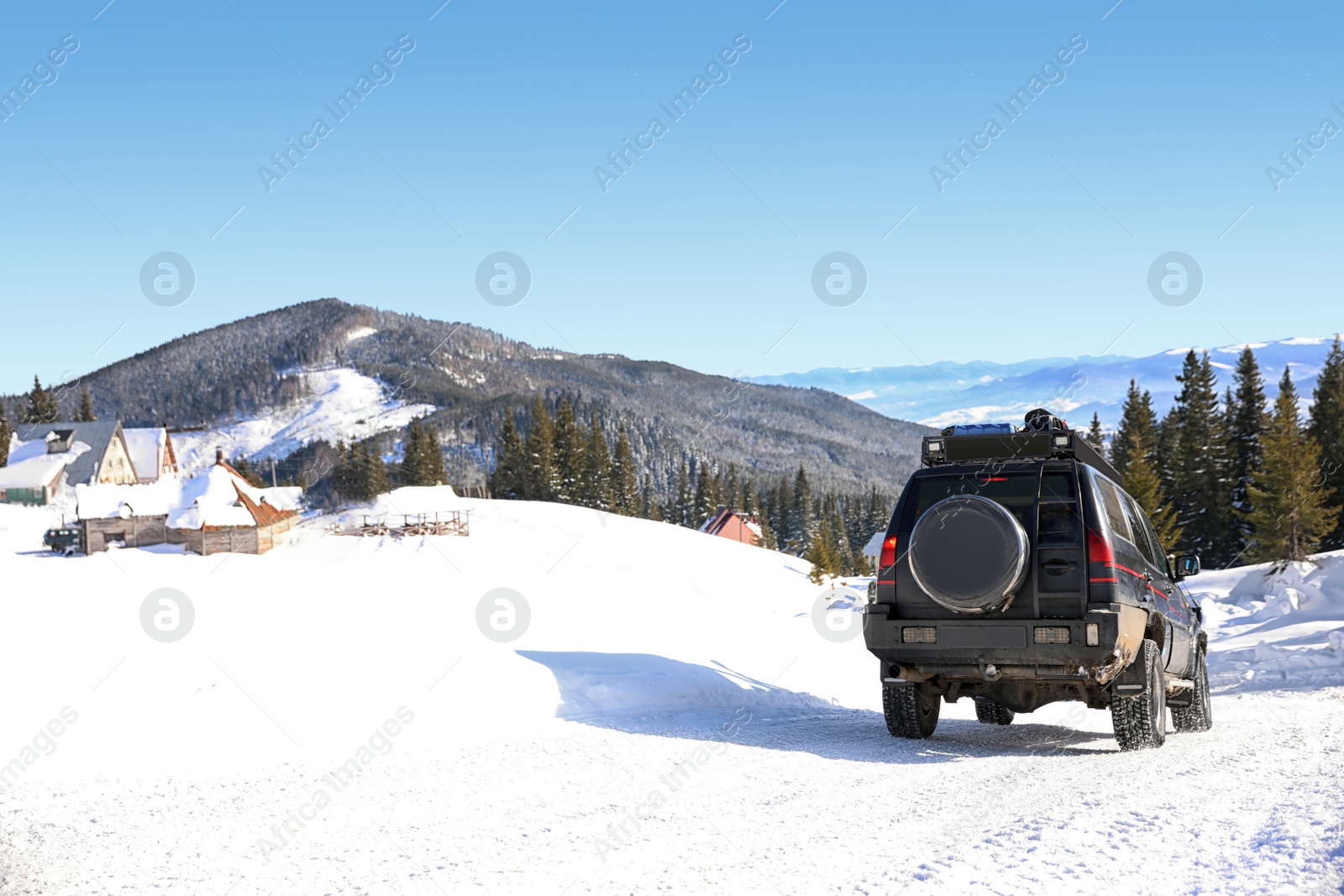 Photo of Modern car on snowy country road. Winter vacation