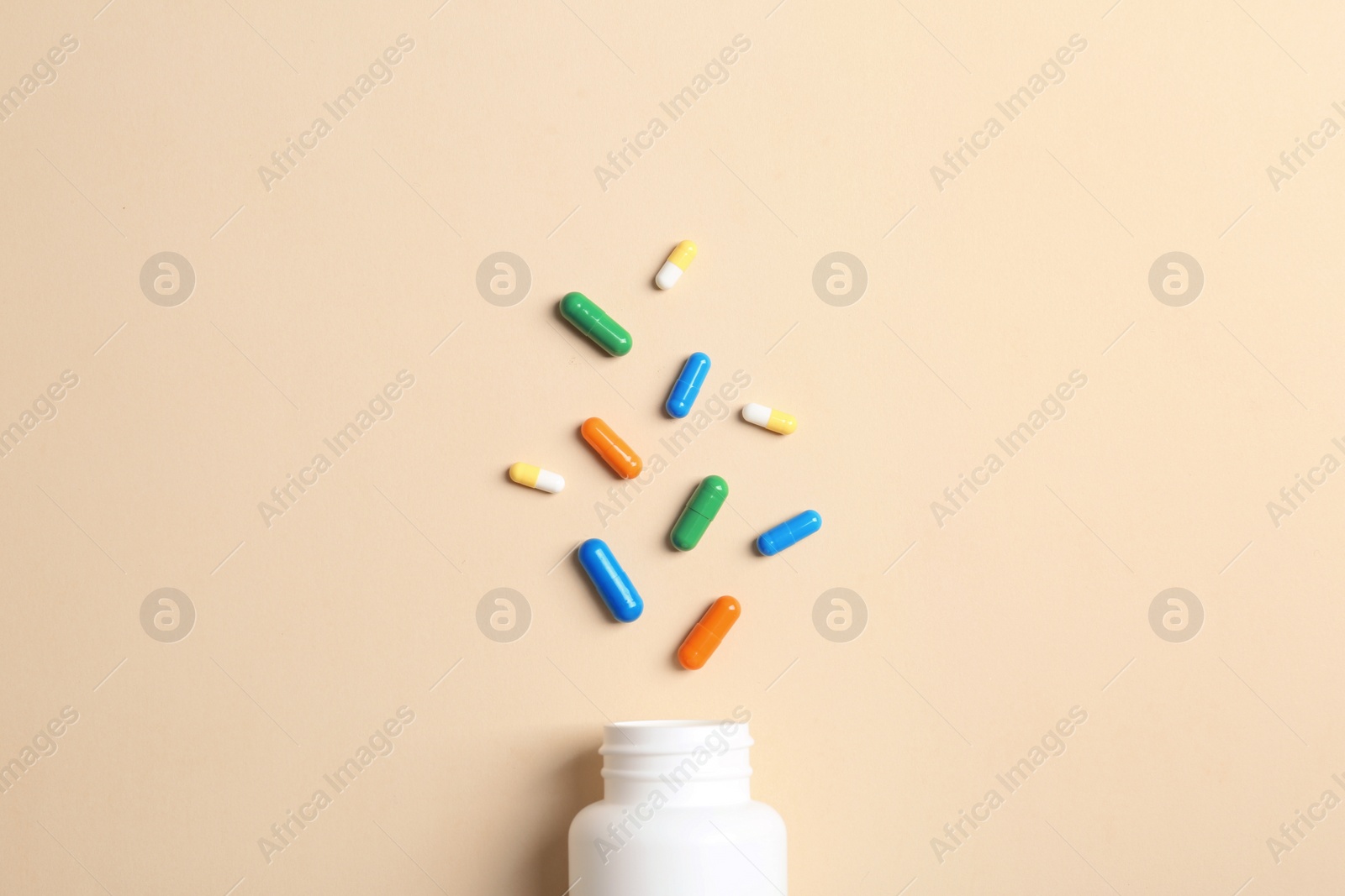 Photo of Flat lay composition with bottle and pills on color background