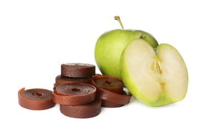 Photo of Delicious fruit leather rolls and apples on white background