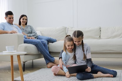 Photo of Family in living room with comfortable sofa