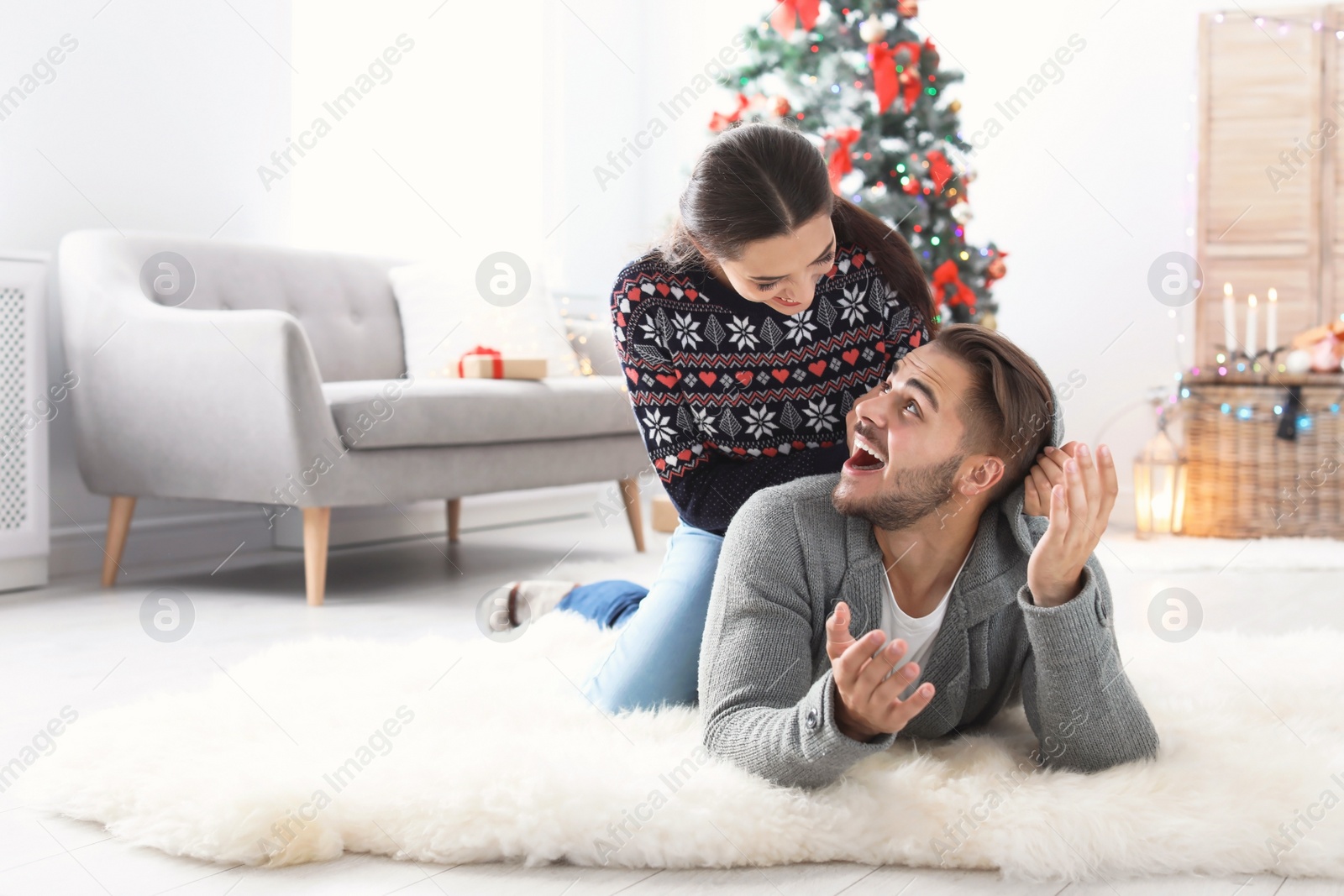 Photo of Happy young couple celebrating Christmas at home