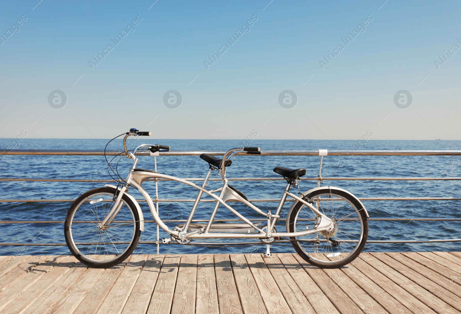 Photo of Tandem bike near sea on sunny day