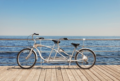 Photo of Tandem bike near sea on sunny day