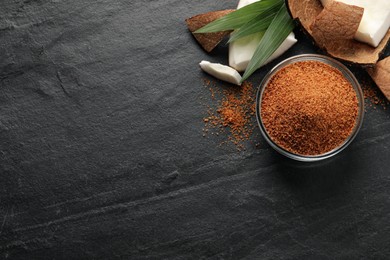 Photo of Flat lay composition with natural coconut sugar on black table, space for text