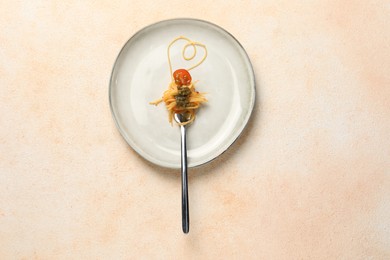 Photo of Heart made with spaghetti and fork on beige table, top view
