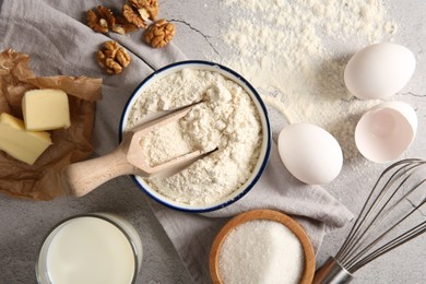 Different ingredients for dough and whisk on table, flat lay