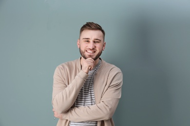 Photo of Portrait of confident young man on color background