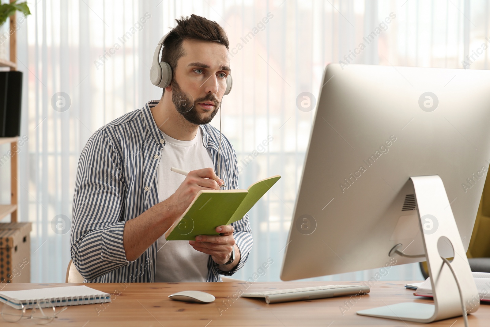 Photo of Online test. Man studying with computer at home