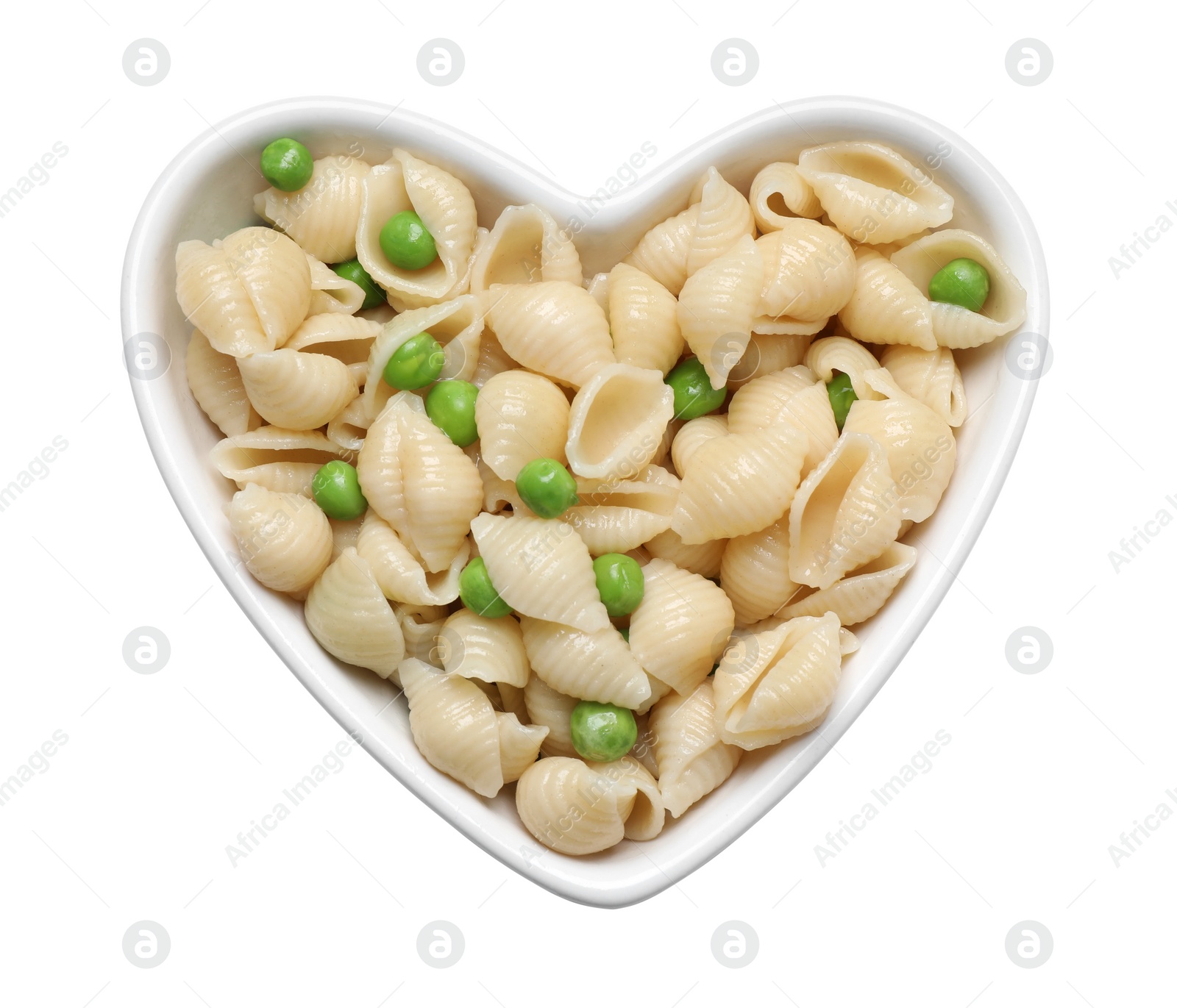 Photo of Heart shaped bowl with tasty pasta and peas on white table, top view