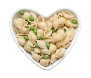 Photo of Heart shaped bowl with tasty pasta and peas on white table, top view