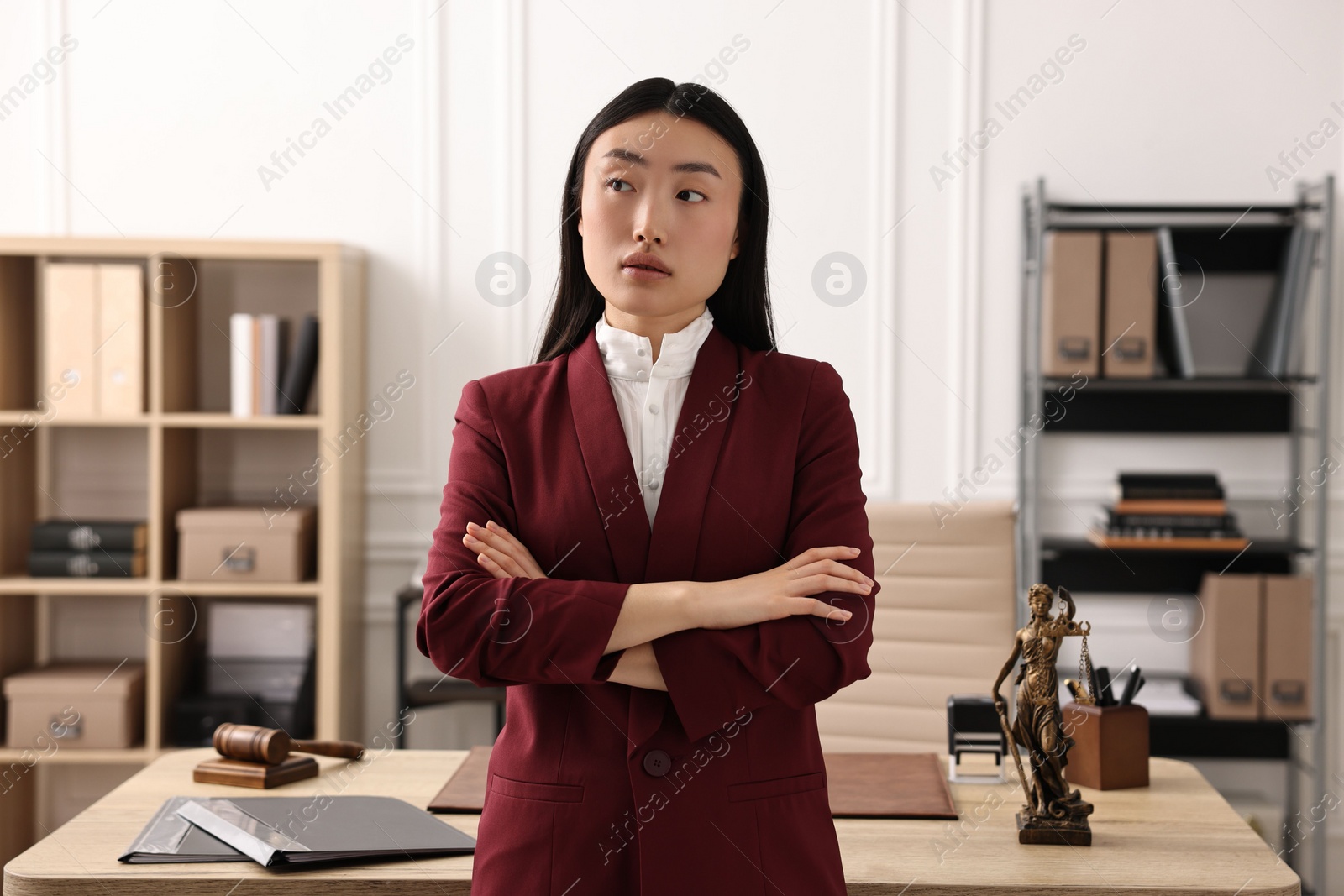 Photo of Portrait of notary with crossed arms in office