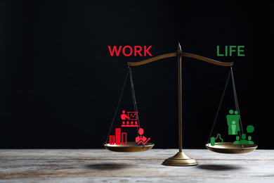 Image of Work-life balance concept. Scale with images on table