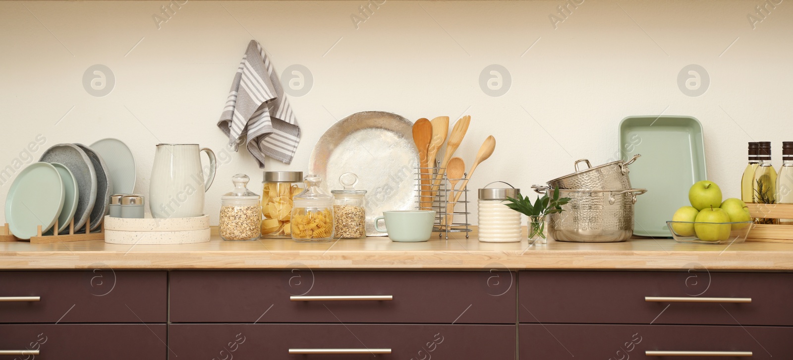 Photo of Stylish kitchen interior with wooden countertop and wall cabinets