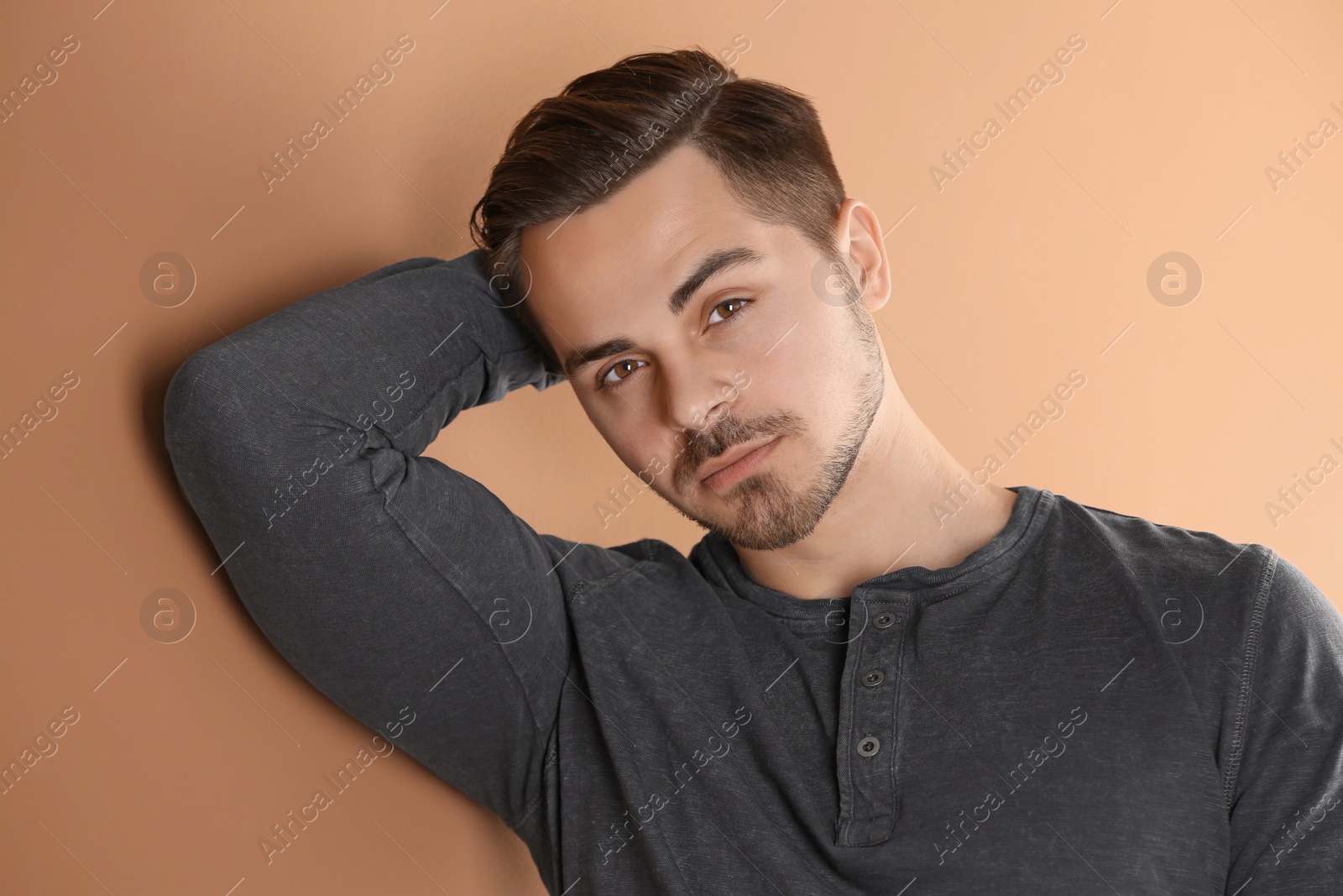 Photo of Portrait of young man with beautiful hair on color background