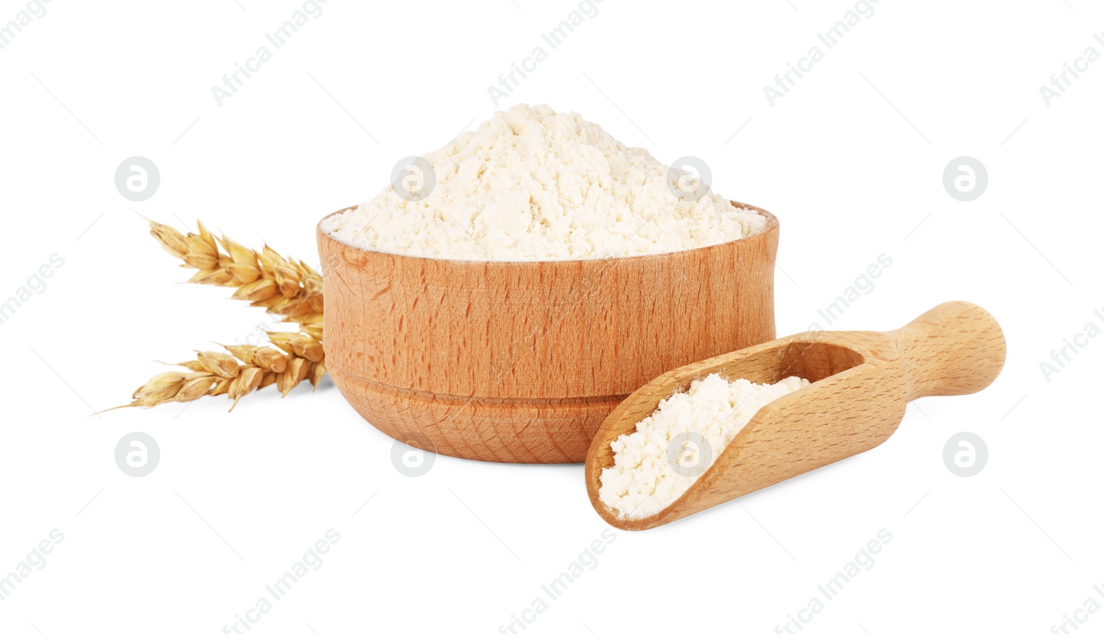 Photo of Wooden bowl and scoop with wheat flour isolated on white