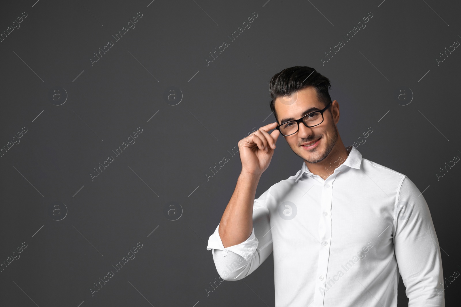 Photo of Portrait of handsome young man and space for text on black background