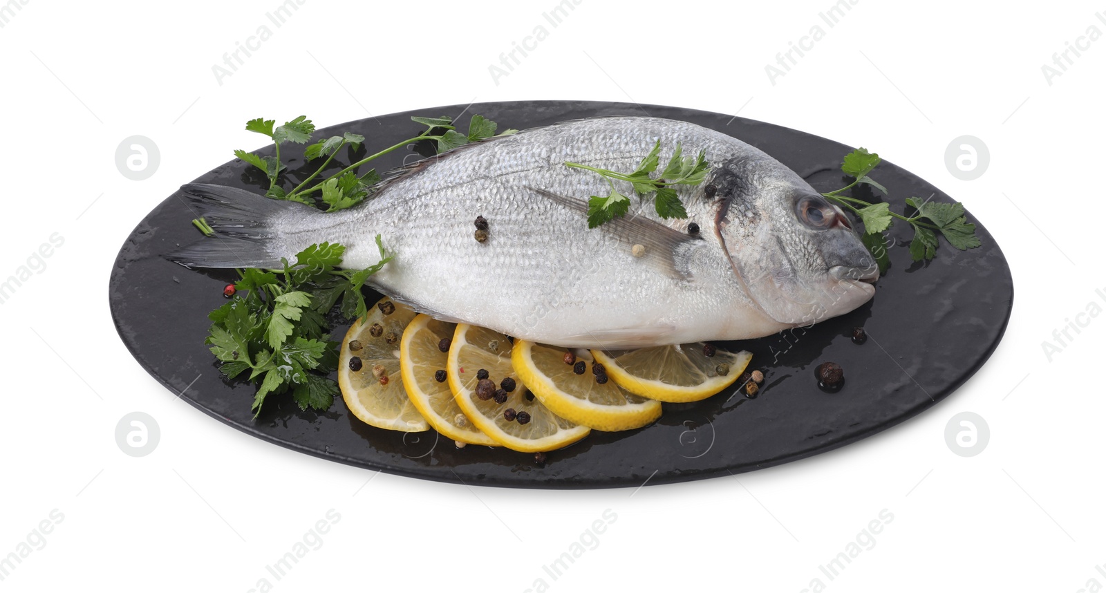 Photo of Raw dorado fish, parsley, lemon slices and peppercorns isolated on white