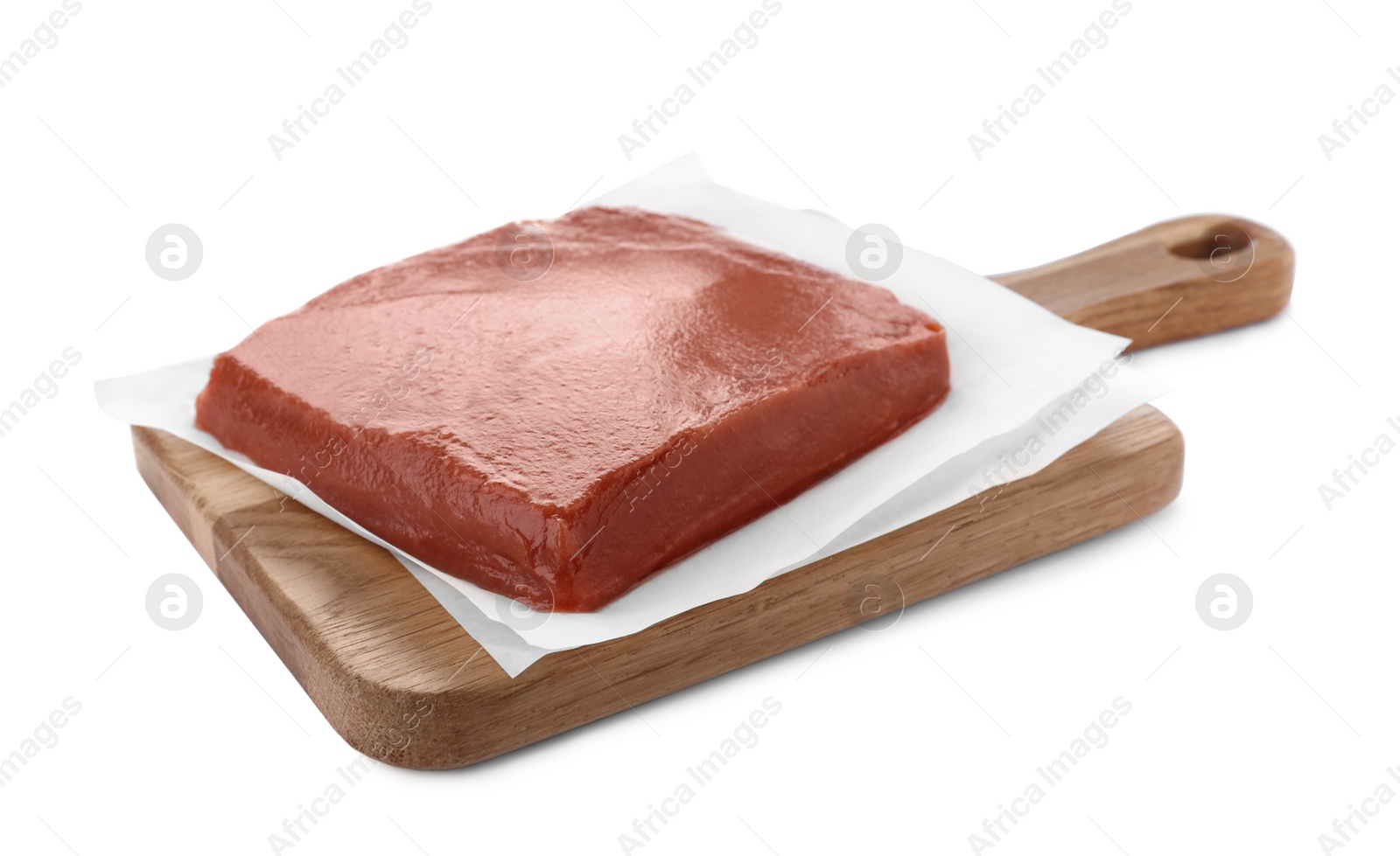 Photo of Wooden board with fresh quince paste isolated on white