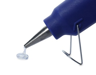 Photo of Dripping hot glue from gun on white background, closeup