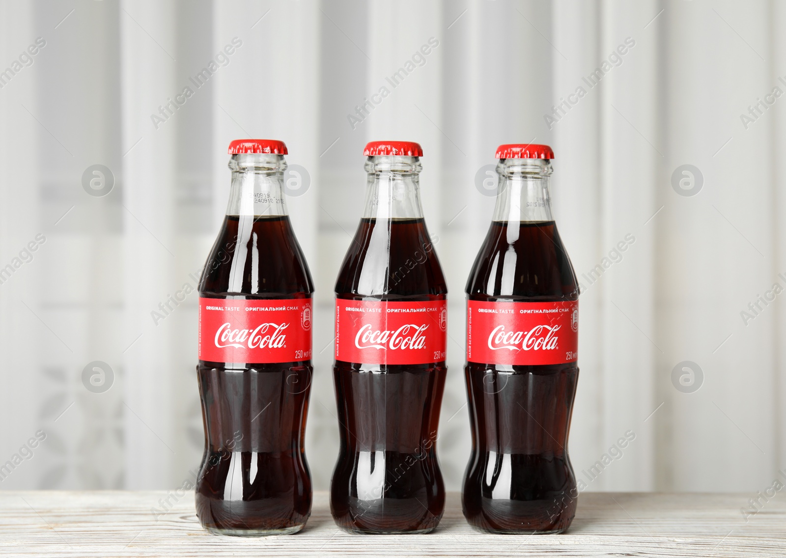 Photo of MYKOLAIV, UKRAINE - NOVEMBER 15, 2018: Bottles of Coca Cola on table indoors