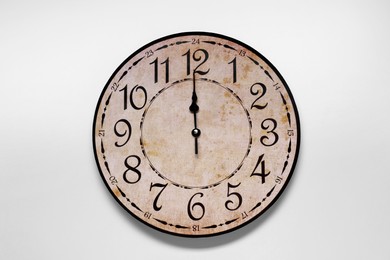 Photo of Stylish round clock on light blue background, top view. Interior element