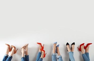 Young women in elegant shoes on white background, closeup