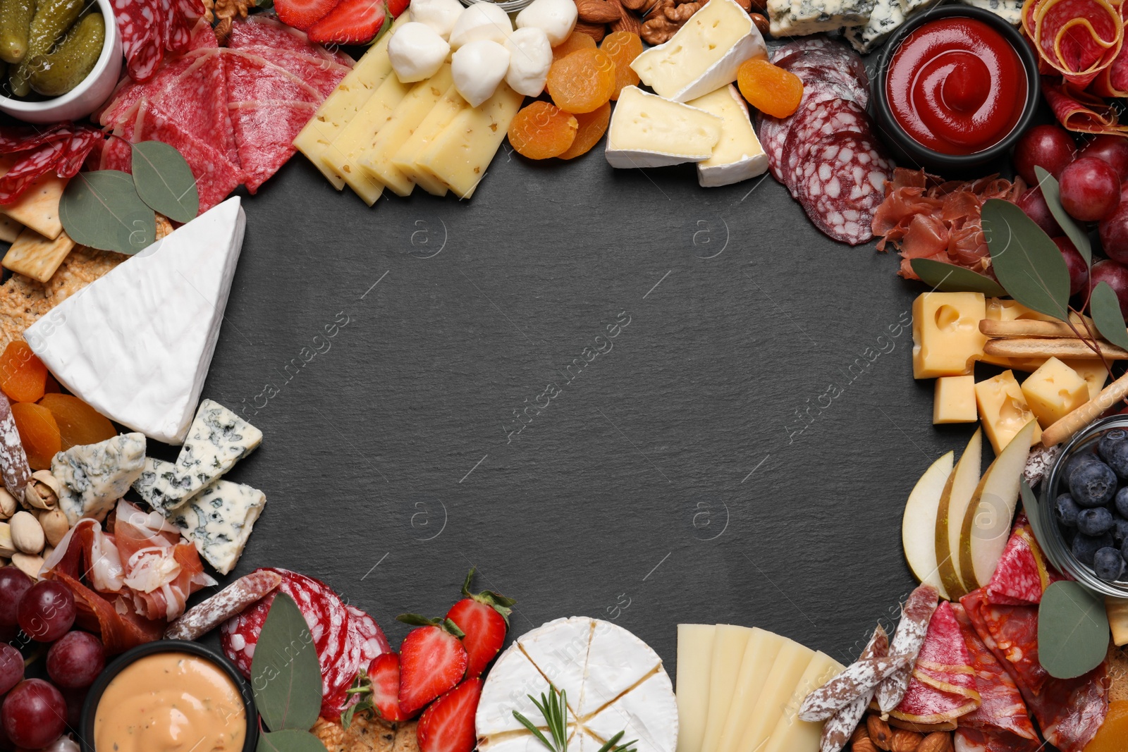 Photo of Frame of assorted appetizers on black background, flat lay. Space for text