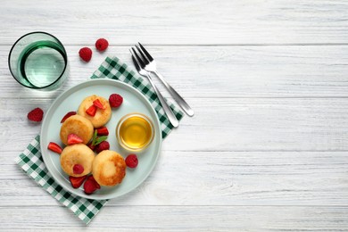 Delicious cottage cheese pancakes with fresh berries and honey on white wooden table, flat lay. Space for text