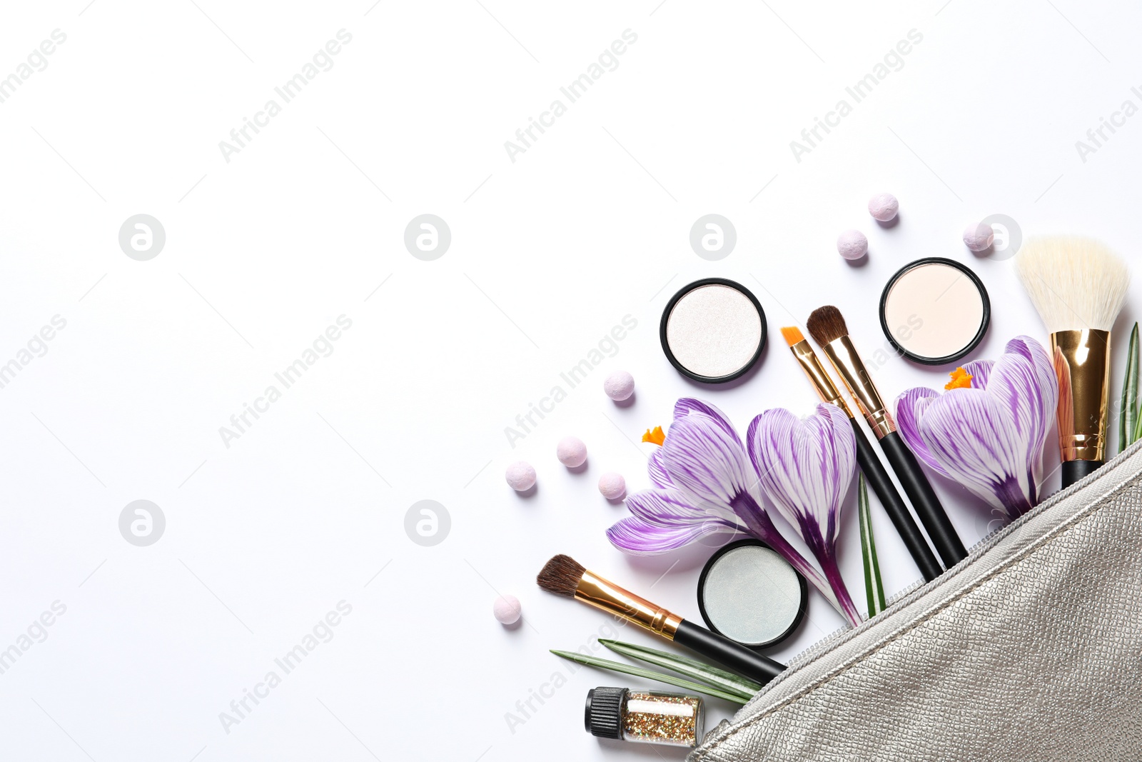 Photo of Makeup products, flowers and cosmetic bag on white background, top view