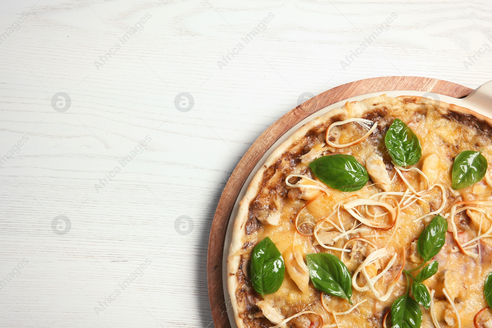 Photo of Board with delicious homemade pizza and space for text on wooden background, top view