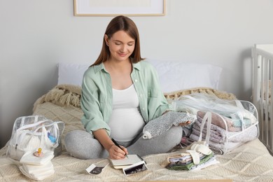 Photo of Pregnant woman preparing list of necessary items to bring into maternity hospital in bedroom