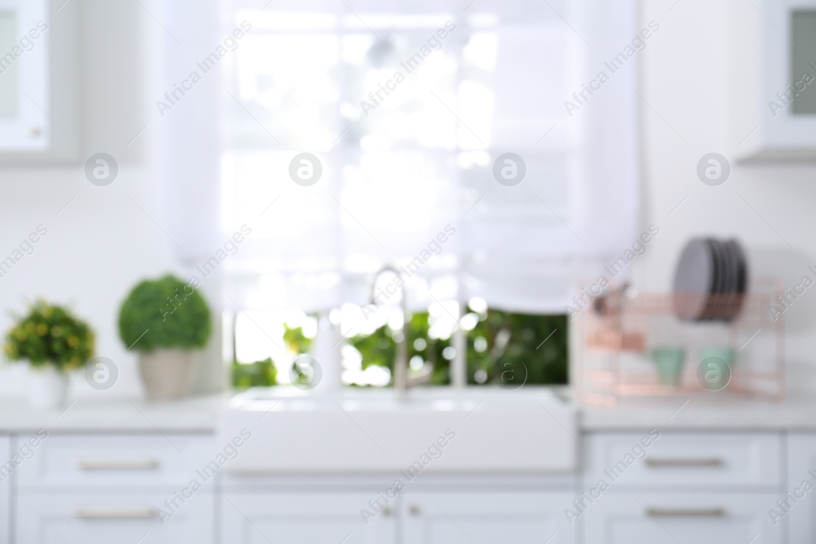 Photo of Blurred view of modern stylish kitchen interior