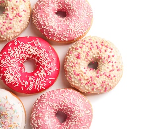 Photo of Delicious glazed doughnuts with sprinkles on light background, top view