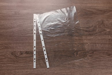 Photo of Punched pockets on wooden table, flat lay